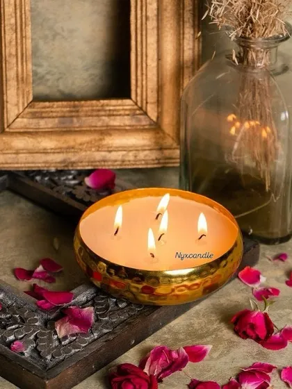 Our handcrafted urli candles are perfect for festive occasions like Diwali or as elegant wedding decor. This multi-wick candle, set in a hammered brass urli and adorned with rose petals, creates a stunning centerpiece and a warm, inviting glow.