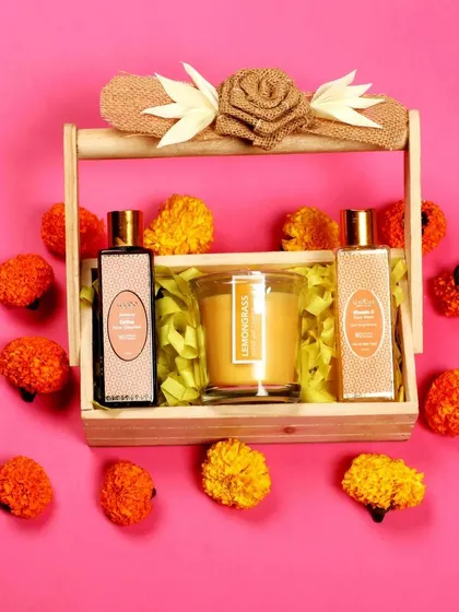 A vibrant flat-lay of a face cleanser set against a bright pink background, styled with flowers for a cheerful look.