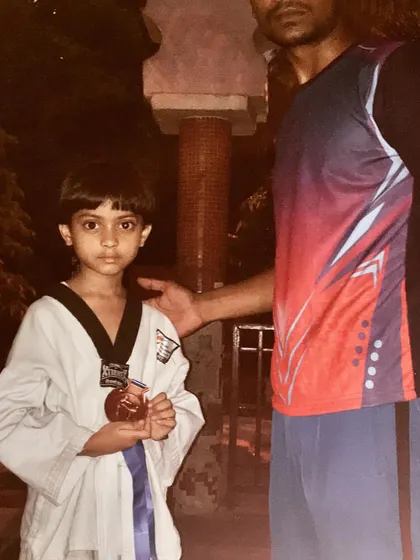 This young blue belt holder stands proudly with his medal. It's rewarding to see students progress and succeed at every level of their training.