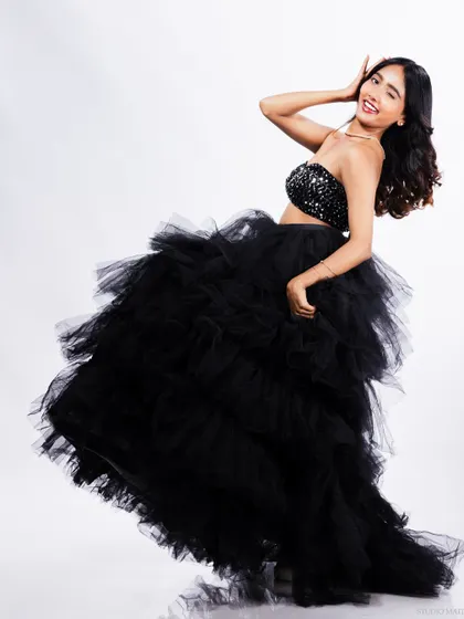 A playful and joyful shot of the model in the black tulle gown, winking at the camera. Capturing personality is key for a standout model portfolio.