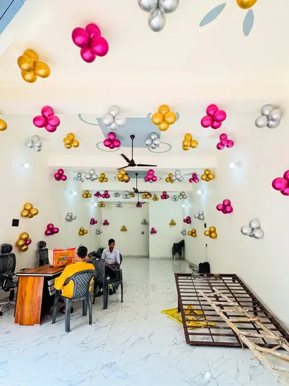 The interior of the office is decorated with balloon clusters on the ceiling in matching colors for the inauguration event.