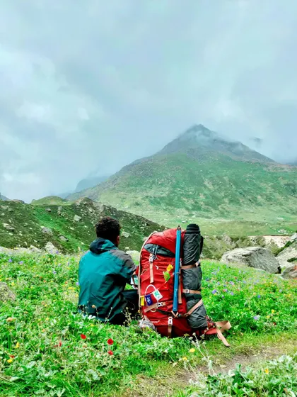 A moment of solitude on the Pin Parvati trek, with a backpack full of essentials and a mountain full of dreams.