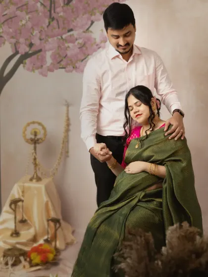 A tender moment where the couple holds hands, their eyes closed in shared anticipation. This pose beautifully captures the emotional connection and the quiet moments of pregnancy.