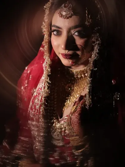 A moody and captivating bridal portrait. The circular light effect draws all attention to her expressive eyes and the rich details of her wedding attire.