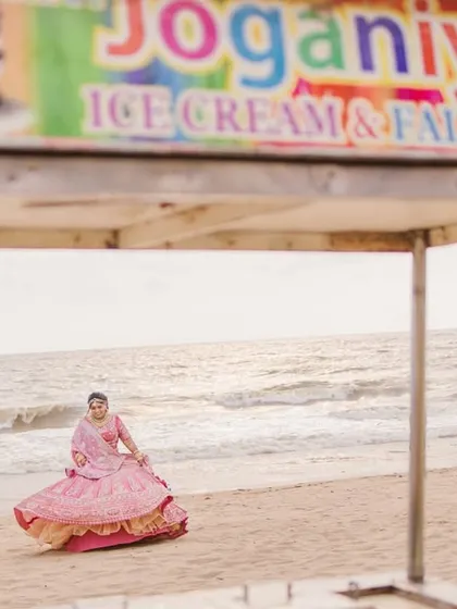 A quirky and fun shot of the bride on the beach, framed by a local ice cream cart. We love incorporating local elements to make your destination photos unique.