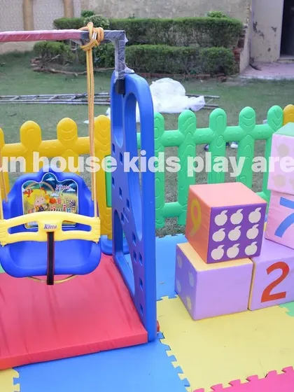 A close-up of the toddler swing, a safe and fun addition to our rainbow play area package.