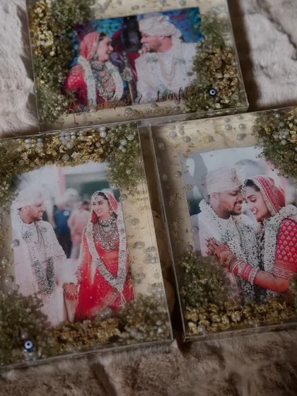 A set of three matching photo frames, perfect for gifting to parents or keeping as a series. Each frame uses the same wedding flowers to create a cohesive look, while capturing different beautiful moments from the wedding day.