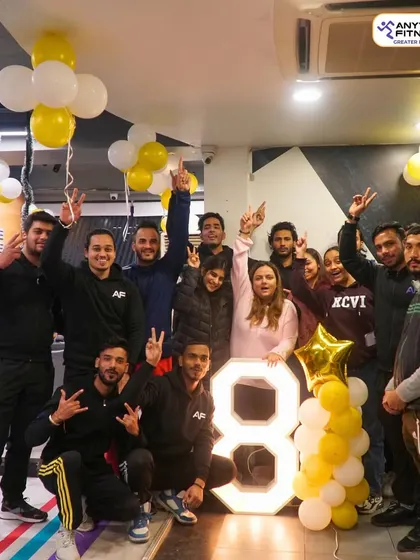 Celebrating 8 amazing years. Our team and members pose with a giant "8," marking our anniversary. We're grateful to everyone who has been a part of our journey.