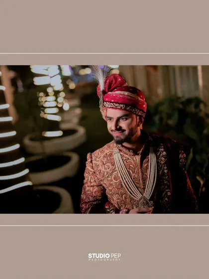 A stylish, wide-shot of Akhilesh, his portrait framed by the elegant decor of the wedding venue.