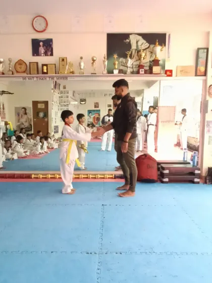 A young student receives his yellow belt.