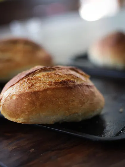 Close-up on perfectly baked dinner rolls, a product of our baking and pastry module.