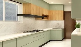 A modern kitchen with a refreshing color palette of sage green and natural wood. The handleless cabinets and white countertop create a clean, minimalist look that is both calming and stylish.