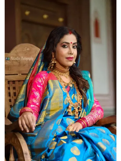 A regal portrait of the actress in a classic pose, showcasing the layered necklaces and choker.