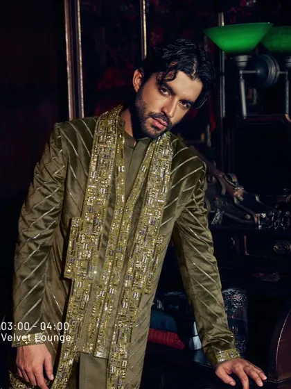 When style goes hand in hand with vivacious vibes. This olive green velvet jacket with heavy gold embroidery is a showstopper, designed for a season that speaks volumes.
