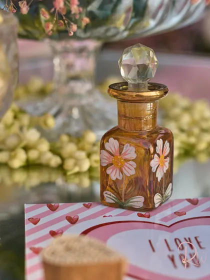 The beautiful, hand-painted ittar bottle, a perfect example of a personalized element that doubles as decor.