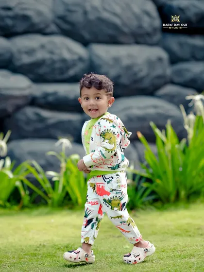 A happy boy taking a walk in our garden. We capture kids in motion to get those natural smiles and energetic poses.