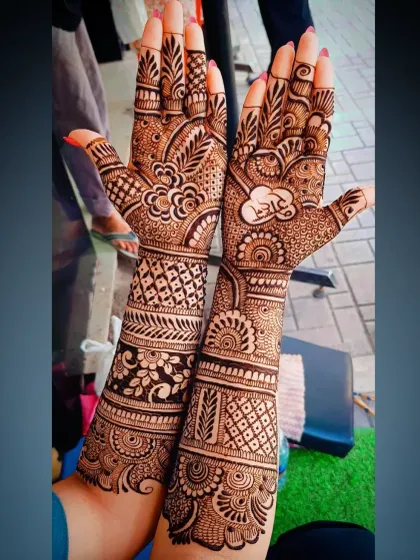 A close-up showing the name 'Ram' written in Hindi script inside a heart, a popular way to personalize bridal mehandi.