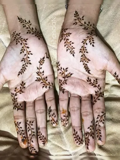 Inspired by nature, this design features delicate leafy vines trailing down the hands and fingers. It's a fresh, organic, and beautifully simple style for any occasion.