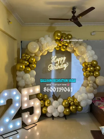 A 25th birthday party with a classic white and gold balloon ring. The large marquee numbers make a bold statement.