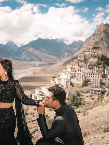A tender kiss on the hand, a classic romantic gesture made epic by the awe-inspiring backdrop of Key Monastery and the Spiti mountain range.