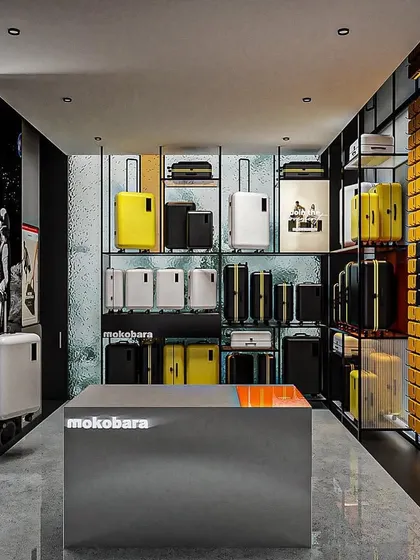The interior concept for Mokobara, designed as a sanctuary for travel enthusiasts. The space uses a dark, moody palette, industrial-style shelving, and vibrant product displays to ignite a sense of wanderlust.