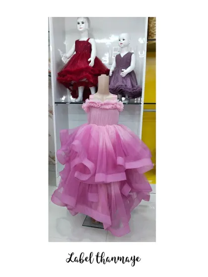 A collection of my party frocks on display. This one in the front is a pink high-low gown with a ruffled neckline.