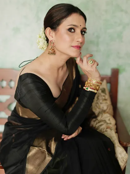 A classic and powerful look: a timeless black saree with a gold border, paired with a pure raw silk full-sleeve blouse.