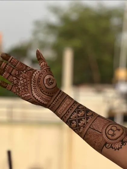 A side view of the arm, highlighting the band of elephants and the personalized initial "MP" at the top.