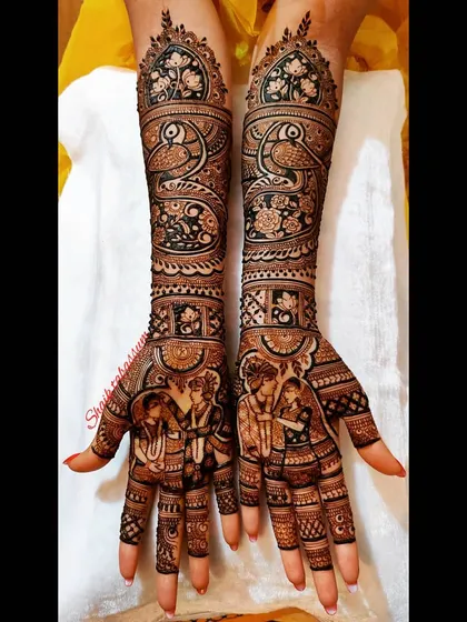 A beautiful design featuring a couple's portrait, surrounded by graceful peacock and floral patterns. The intricate line work and shading give the design a rich, textured look.