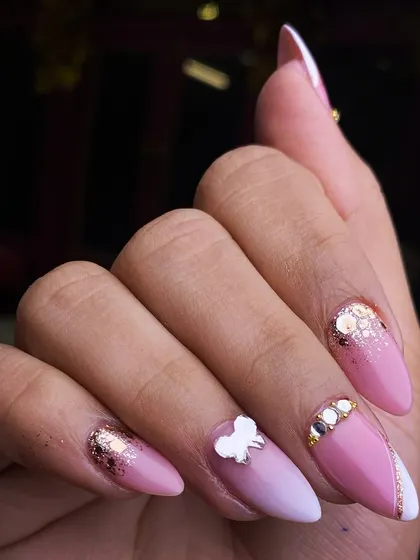 A glamorous pink set featuring a mix of glitter, gems, and a delicate 3D butterfly accent. This design shows how I can layer different elements for a rich and luxurious finish.