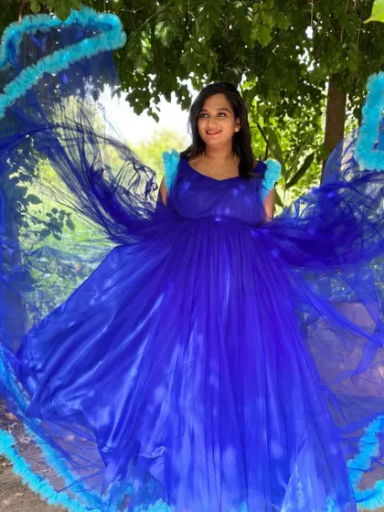This royal blue maternity gown with a dramatic ruffled trail is designed to make a statement. It creates a beautiful circular frame for stunning overhead shots.