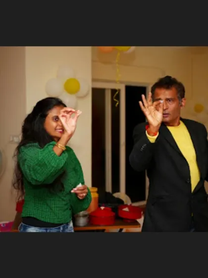 A close-up look at a sleight-of-hand moment with an audience member. These intimate tricks are perfect for engaging smaller groups and showcasing detailed magical skill.