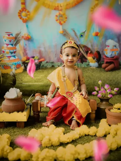 A happy little Krishna surrounded by falling flower petals. This dynamic shot captures the playful and joyous atmosphere of the festival.