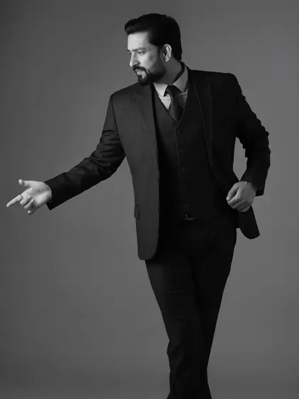 A dynamic pose from Aadesh Chaudhary in a suit. Movement adds energy to a still photograph, making it more engaging.
