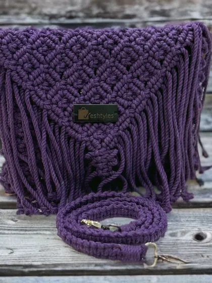A classic fringed sling bag in a deep purple color. This is a great choice if you want to add a pop of color to your wardrobe.