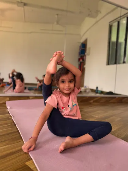 This little girl's flexibility is amazing. Kids are often naturally flexible, and yoga helps them maintain that mobility safely.