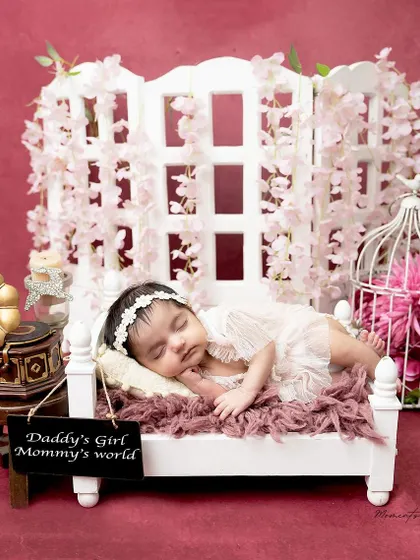 Daddy's girl, Mommy's world. This sweet setup with a personalized sign is a beautiful way to celebrate a new baby girl.