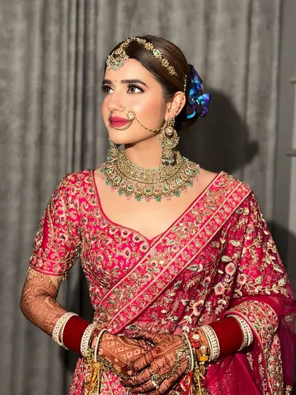 A closer look at this bride's regal profile. The bold lip and defined eyes are balanced with glowing skin, creating a look of pure elegance.