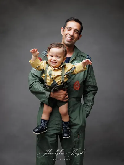 A beautiful, happy portrait of a father and his son. The father's loving embrace and the son's big smile say it all.