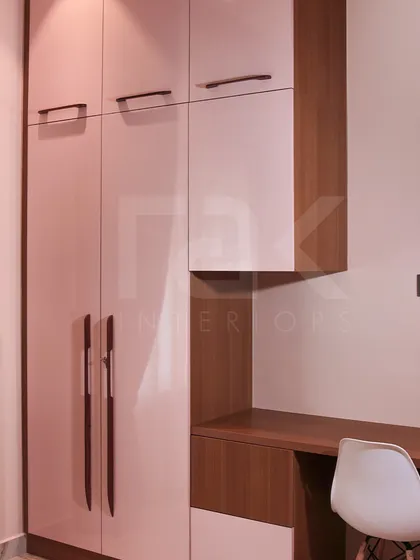 Another view of the pink and wood wardrobe and desk combination, showing how the design fits seamlessly into the room's overall theme.