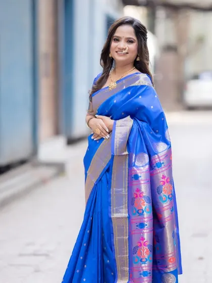 The full look, featuring a stunning royal blue Paithani saree. The makeup is kept minimal to balance the richness of the saree.