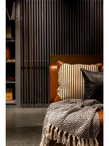 A cozy seating area with a leather couch, providing a comfortable spot for customers to relax and review samples.