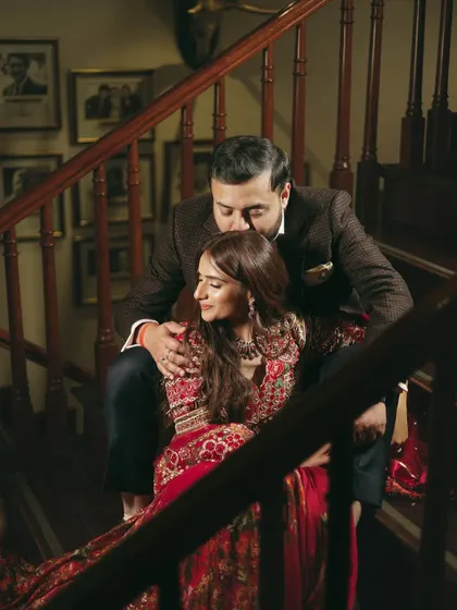 An intimate and romantic portrait of the couple. The warm, moody lighting adds to the romantic atmosphere of their pre-wedding dinner.