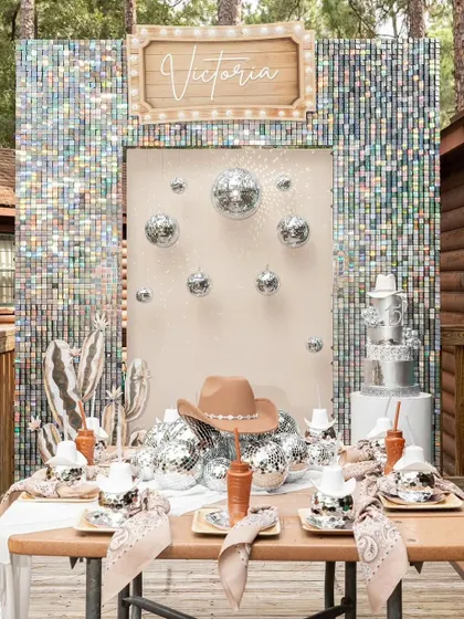 The full glittering cowboy theme, including a themed tablescape with disco ball cups and cowboy hat details. I design the entire experience, not just the backdrop.