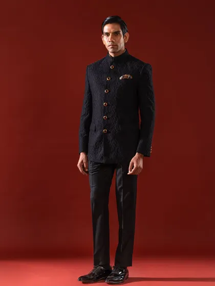 The Bandhgala is a timeless expression of Indian regality, and our interpretation elevates it further. This bespoke textured bandhgala jacket, shown in a classic black, demonstrates our commitment to sharp tailoring and sophisticated design for formal Indian wear.