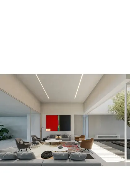 The living space of the Koba House, where a large painting provides a splash of color in an otherwise serene, white interior. The room opens completely to the central courtyard with its signature olive tree.