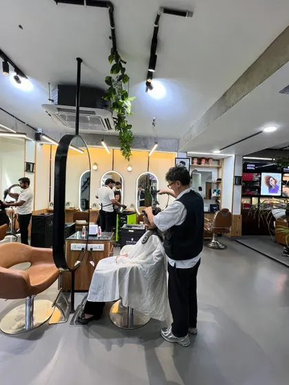 A stylist at work on a client's hair. This image captures the everyday focus and precision that goes into every haircut and style at my salon.
