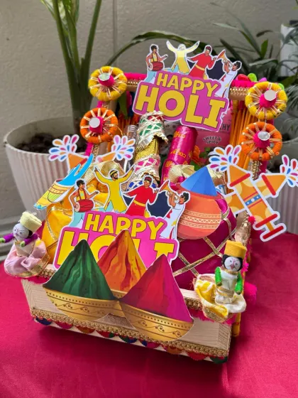 Our premium Holi hamper, priced at ₹1200, is packed in a beautifully decorated cart. It’s filled with premium snacks, drinks, and everything you need for a fantastic celebration.