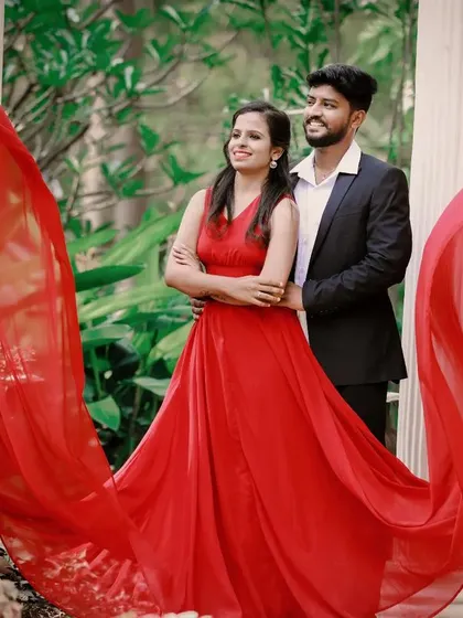 Our red flying dress creates a beautiful frame around this couple during their garden photoshoot.