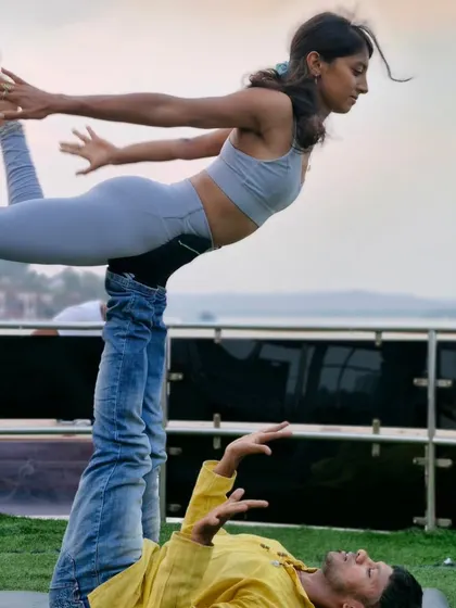 A different perspective of the flying bow pose. You can see the focus and stability required from both partners to hold this beautiful shape.